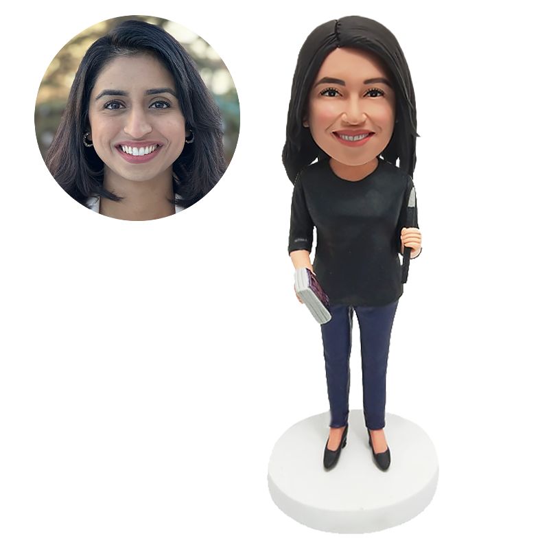 custom made bobblehead lady holding a pen and a book