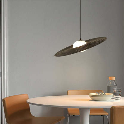 Modern black pendant light above dining table