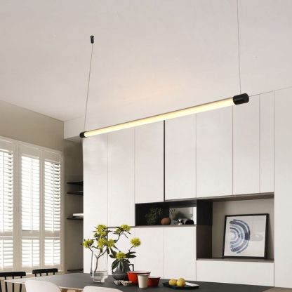 Minimalist linear pendant light above dining table.