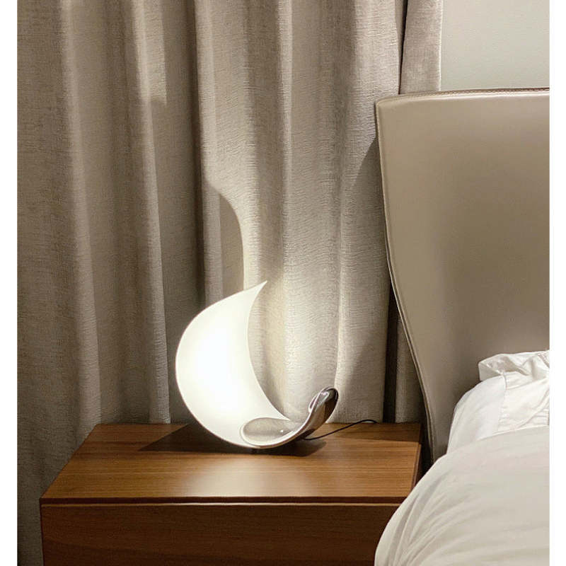 Moon Arc table lamp on a nightstand. Bedroom accent lighting.