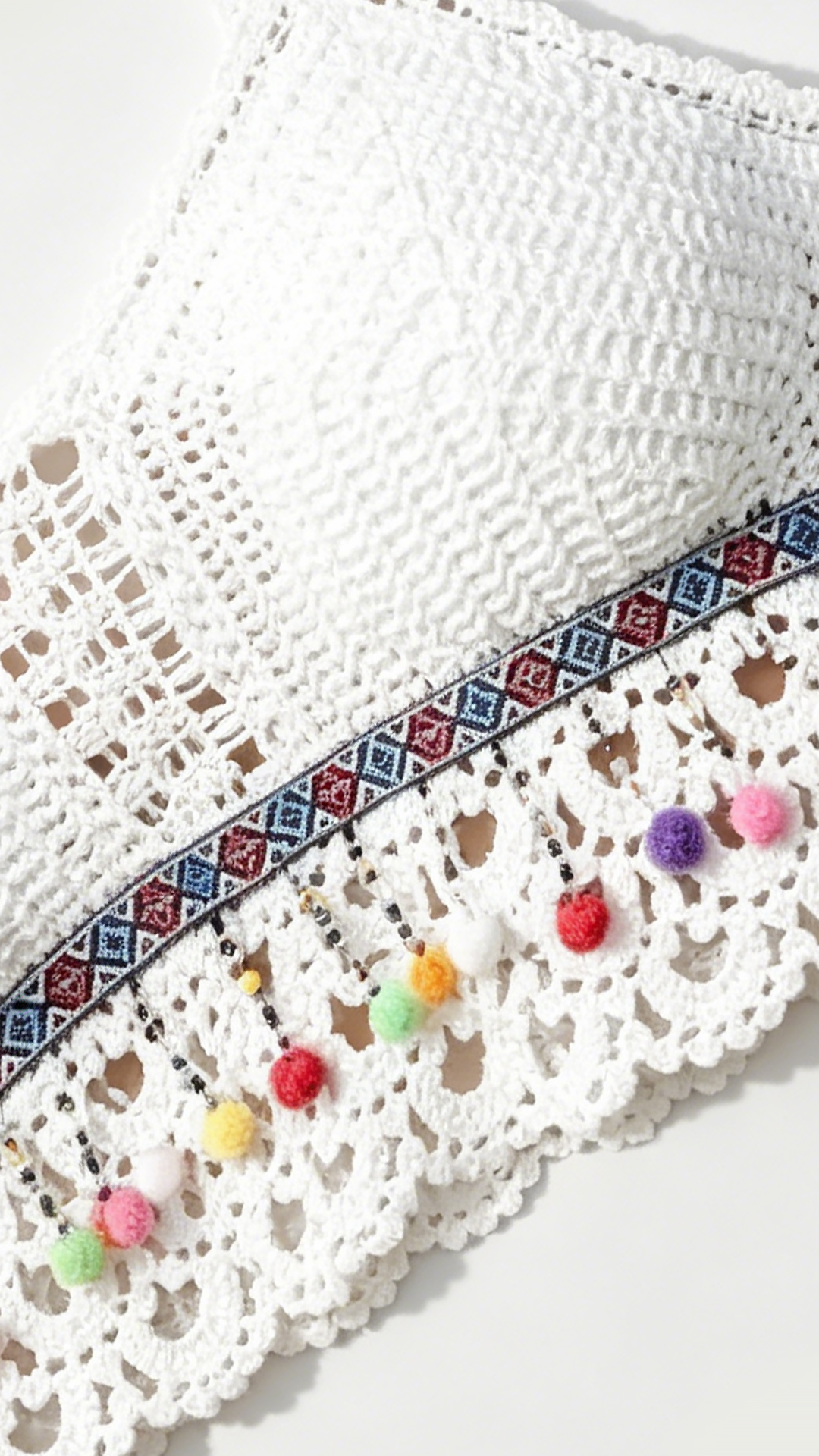 White crochet knit top lace pattern tassel detail close up women bohemian summer fashion