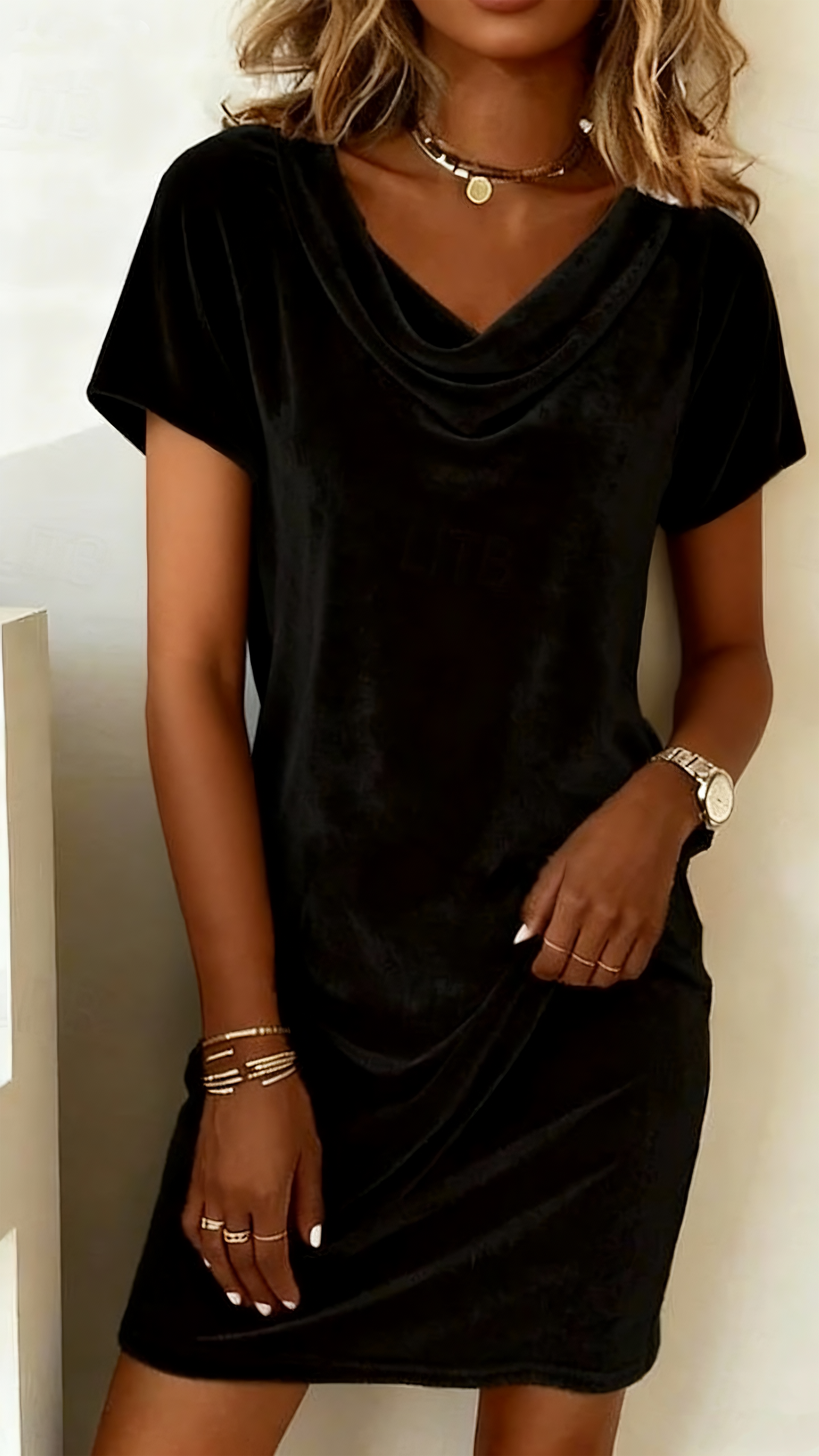 This women's velvet dress with a cowl neck exudes elegance and sophistication.