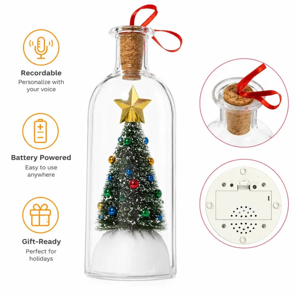 A clear glass bottle Christmas ornament with a cork stopper, red ribbon, and a miniature decorated Christmas tree inside. The image includes feature callouts: 'Recordable' with voice personalization, 'Battery Powered' for anywhere use, and 'Gift-Ready' for holidays, plus two circular inset close-ups showing the cork/ribbon top and the back speaker panel.