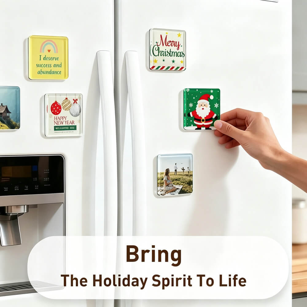 A hand is attaching a square holiday magnet to a white refrigerator door, with other decorative fridge magnets visible around it. The scene includes a text overlay that reads 'Bring The Holiday Spirit To Life.