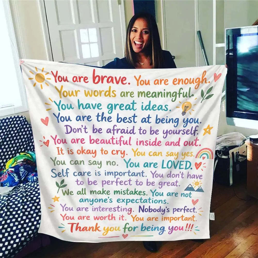 Affirmation blanket styled as a cozy throw on a sofa