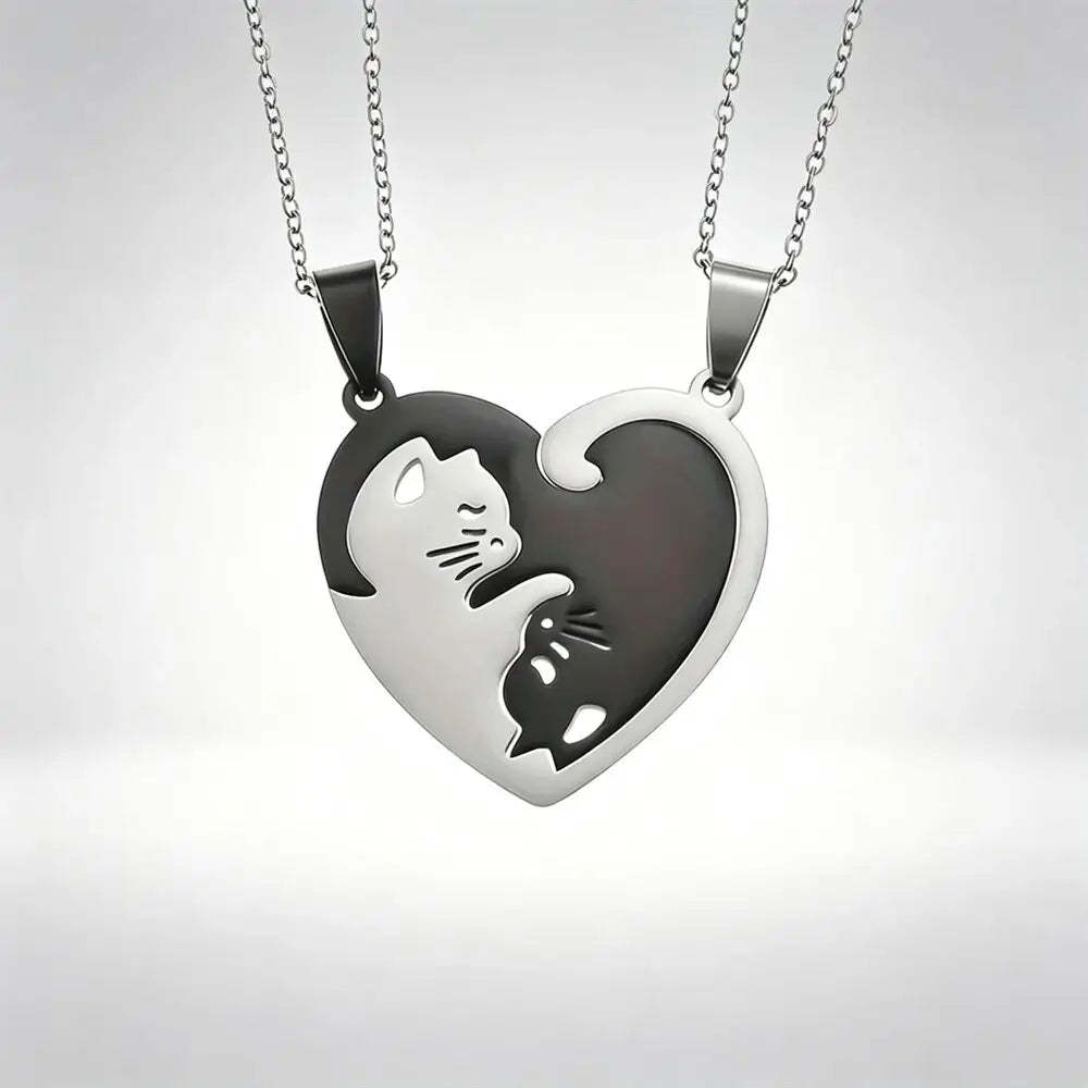 Two matching silver heart-shaped pendant necklaces with cat cutouts, displayed against a light gray gradient background.