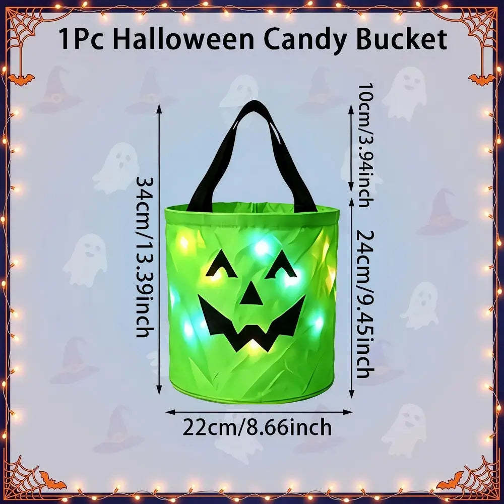A green inflatable Halloween candy bucket with black handles and a jack-o'-lantern face, shown with overlaid dimensions (34 cm tall, 22 cm wide) and a lighted glow effect. The image includes the text '1Pc Halloween Candy Bucket' and a decorative Halloween border with ghosts and spiderwebs.