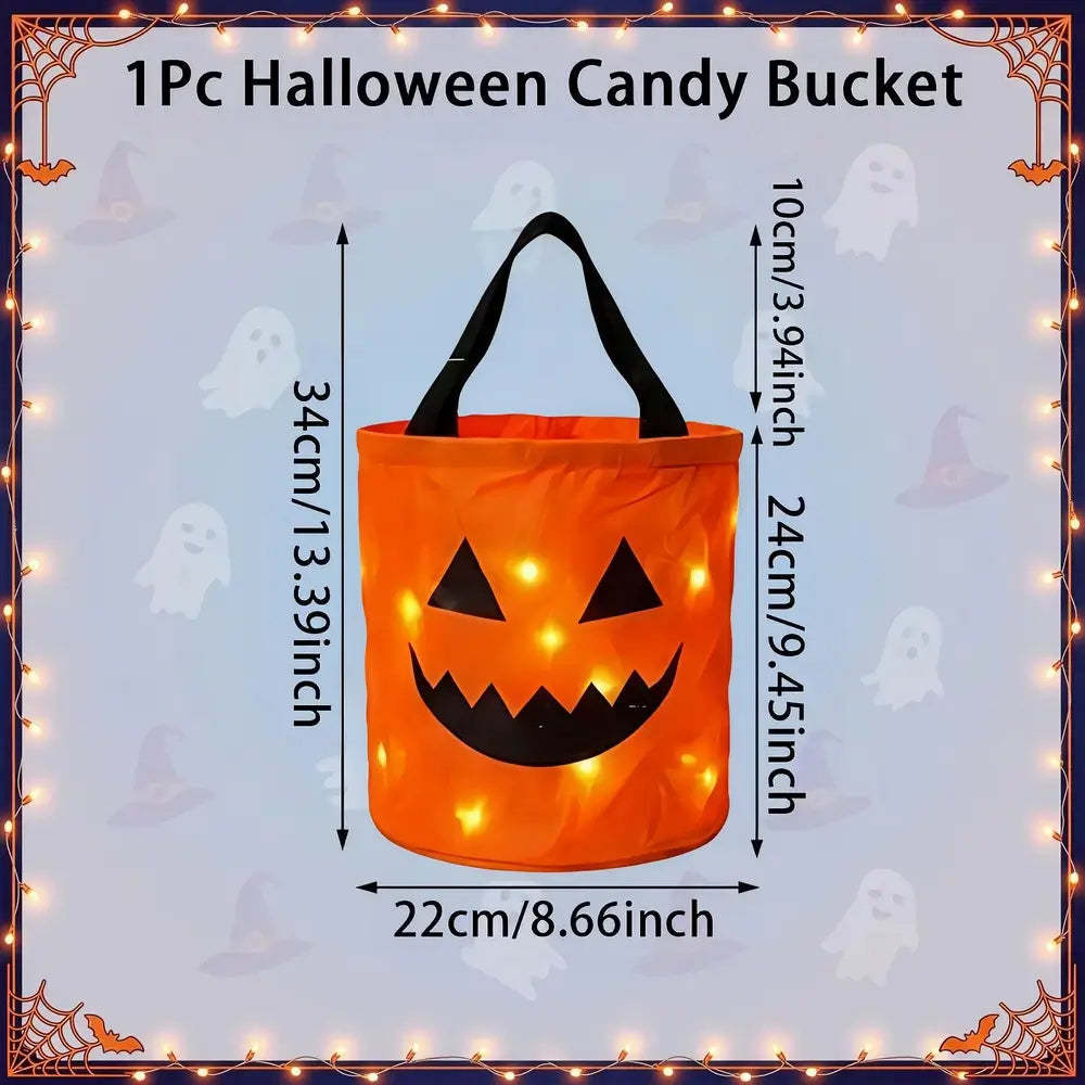 An orange Halloween candy bucket with black handles and a jack-o'-lantern face, shown with dimension labels for height and width on a light blue background with ghost motifs and a decorative border.