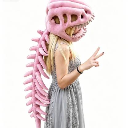 A woman wearing a pink dinosaur skull mask with sharp teeth and a long pink dinosaur spine costume accessory, posed against a plain white background.
