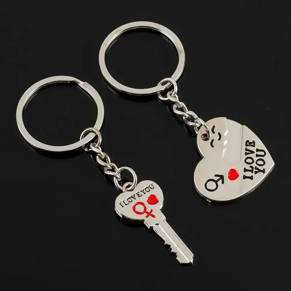 Two silver key-shaped keychains with 'I LOVE YOU' text on a black background