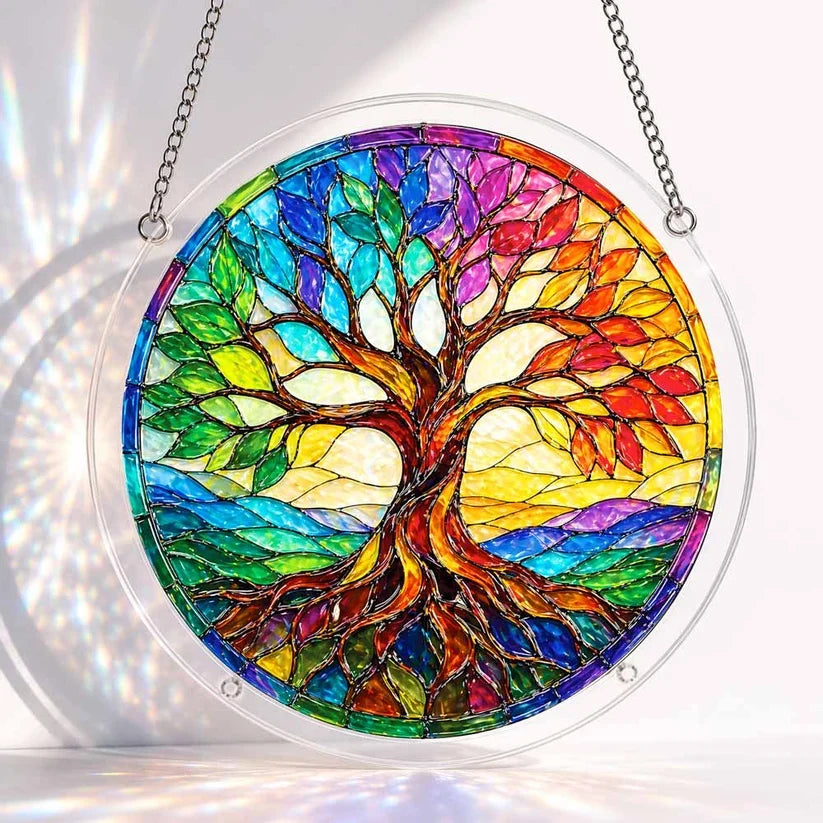 A round acrylic suncatcher featuring a colorful rainbow tree of life with swirling roots and gradient leaves