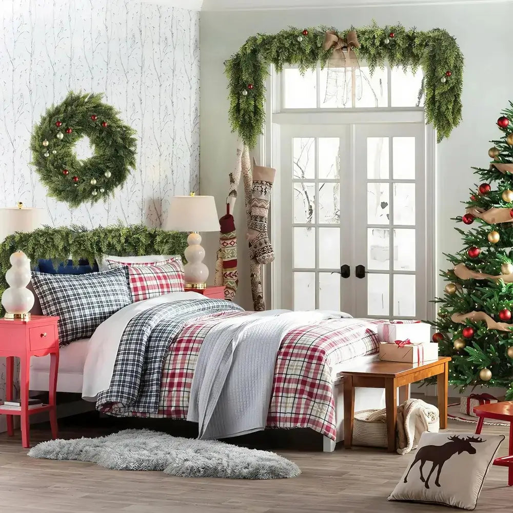 Decorated bedroom with Christmas tree, wreath, and plaid bedding.