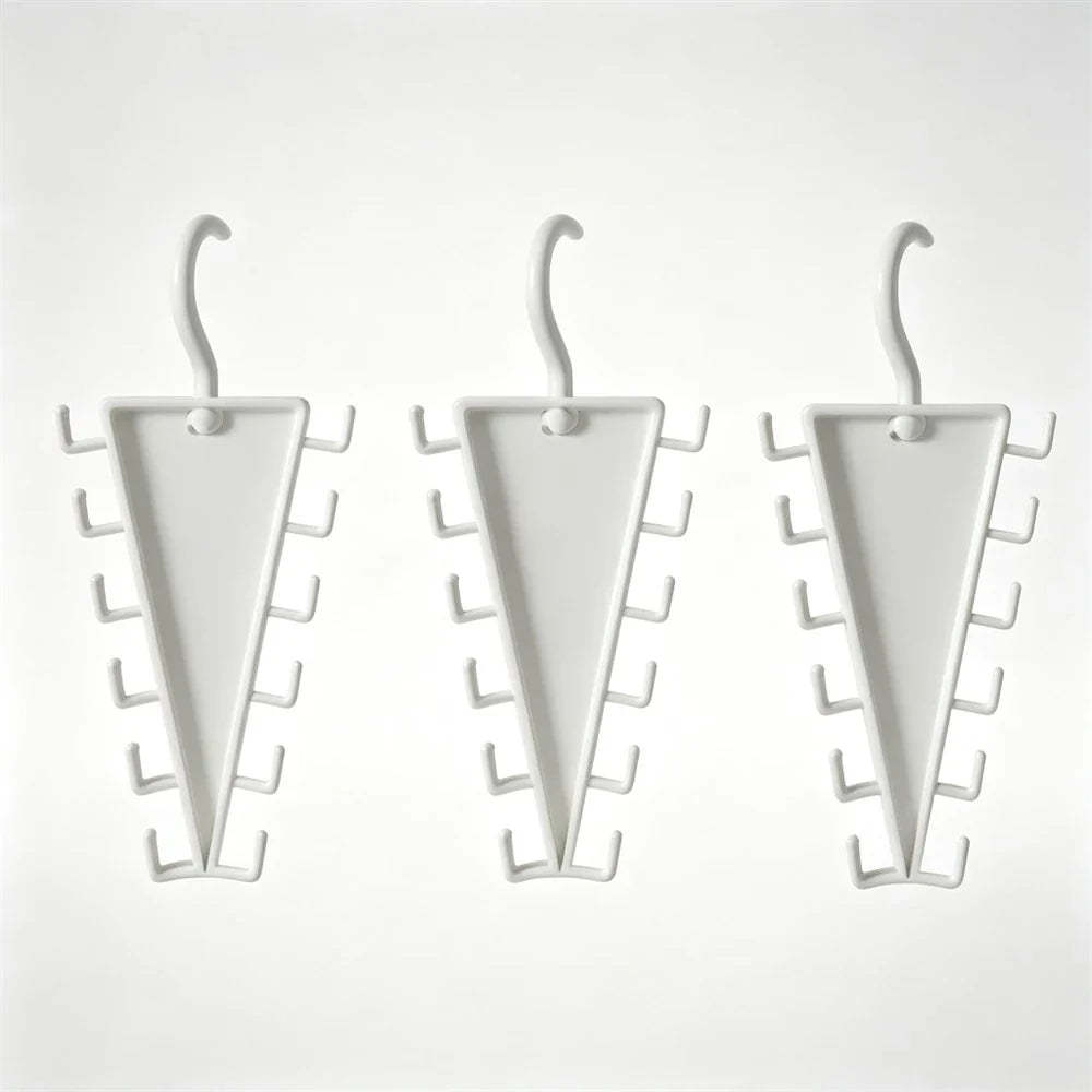 Three white triangular wall hooks with multiple small side hooks, shown on a plain light background.