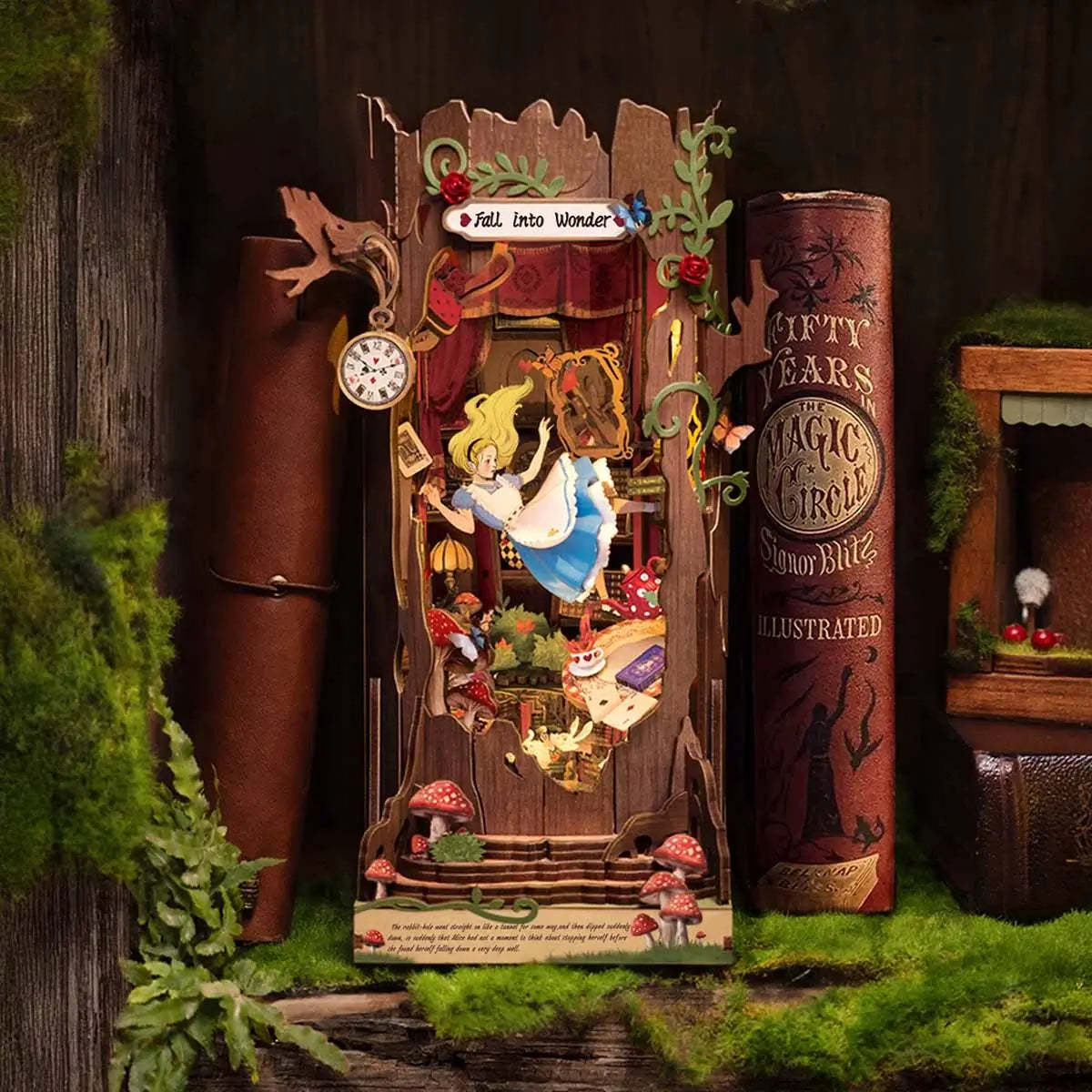 Alice in Wonderland book nook kit with LED lights turned on, glowing warmly inside the miniature scene.