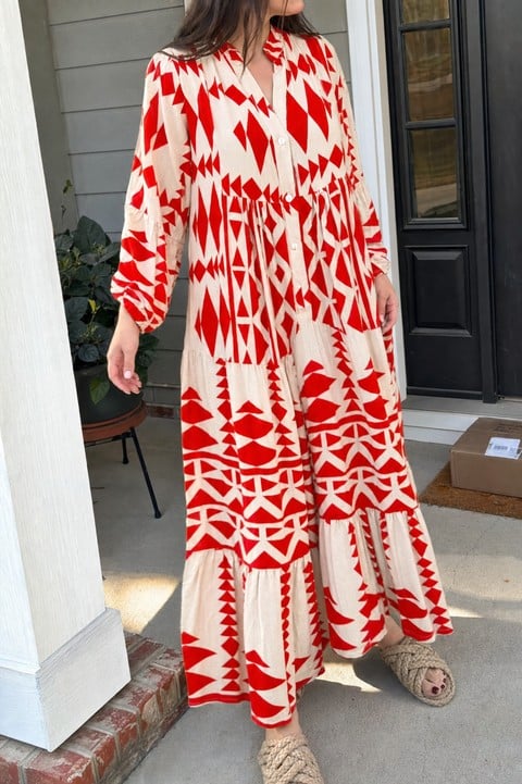 Woman wearing the red geometric maxi dress on a front porch