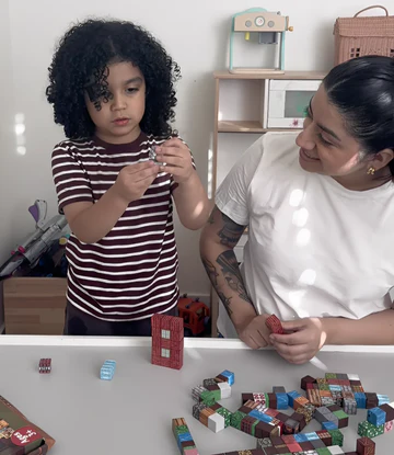 Happy child with magnetic blocks creation