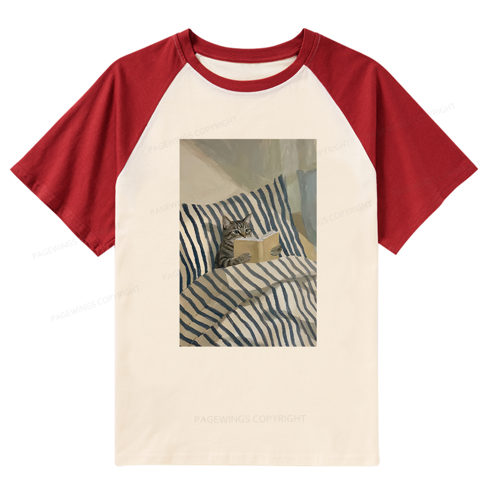 Pagewings Cat Reading Book In Bed Raglan T-shirt
