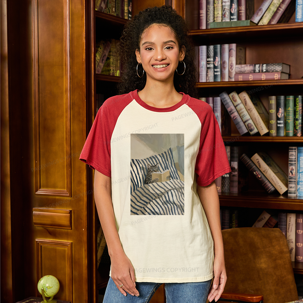 Pagewings Cat Reading Book In Bed Raglan T-shirt