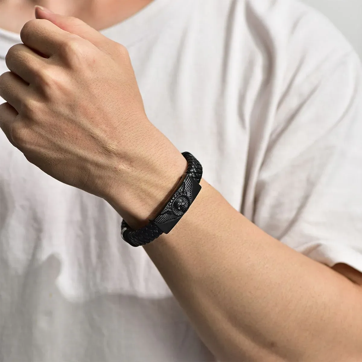 A Man Wearing Leather Braided Skull Wing Bracelet