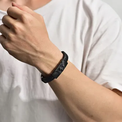 A Man Wearing Leather Braided Skull Wing Bracelet