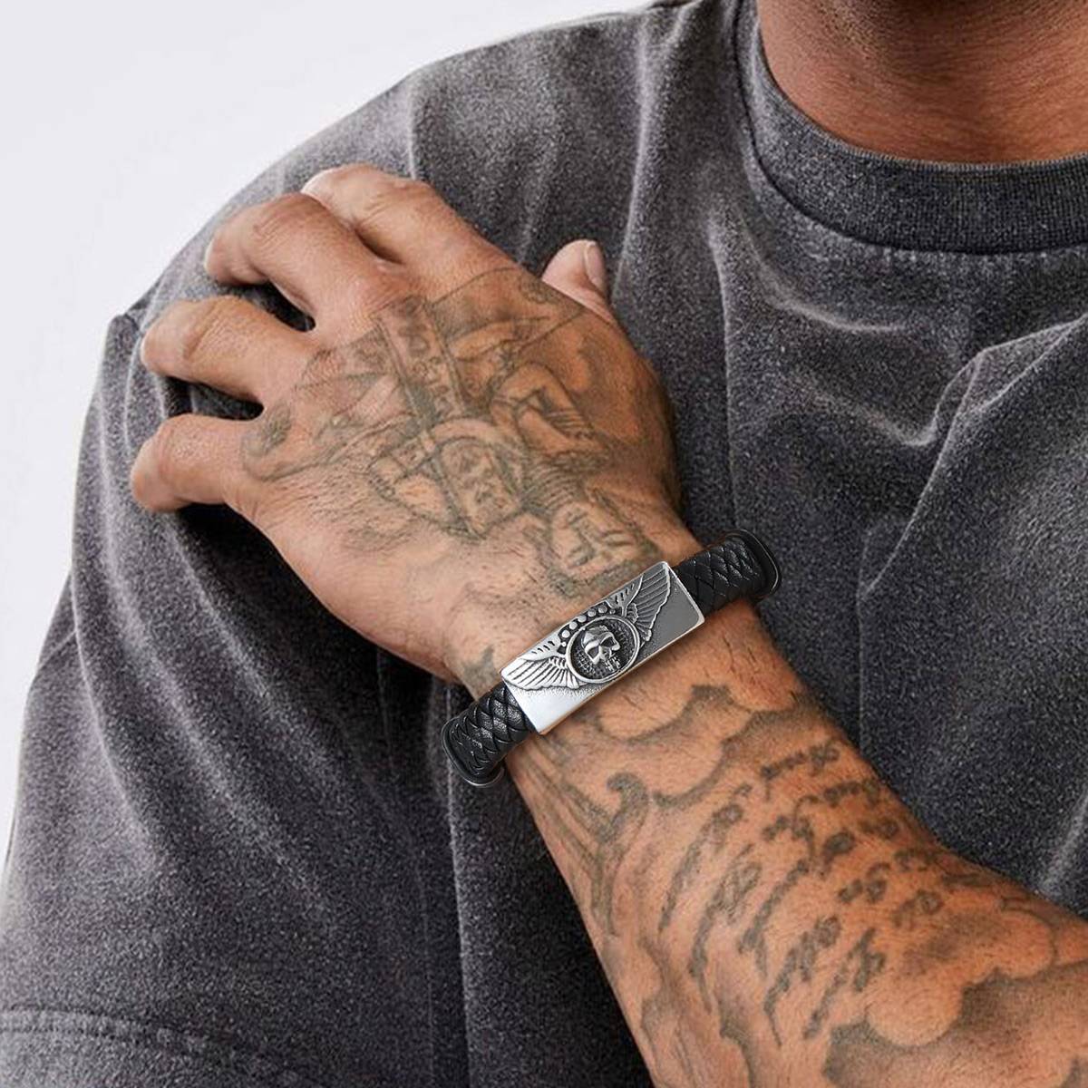 A Man Wearing Leather Skull Wing Bracelet