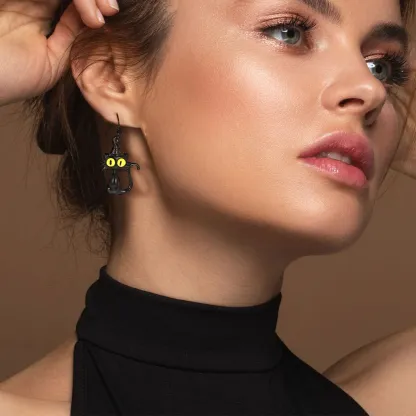 A Woman Wearing Black Cat Drop Earrings