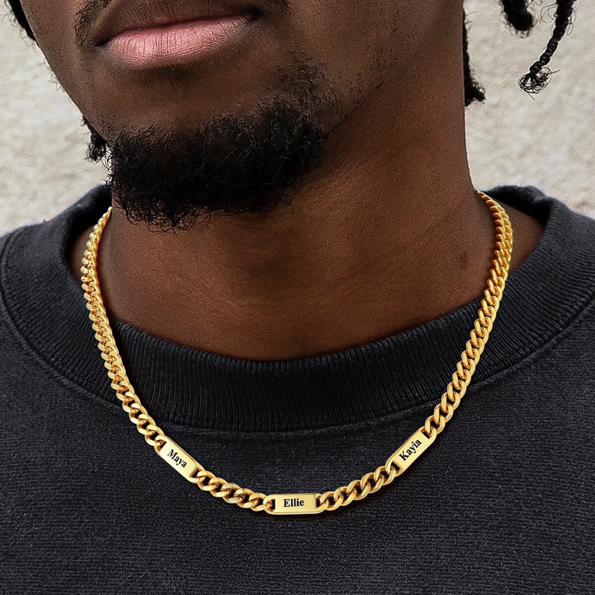man wearing gold name chain