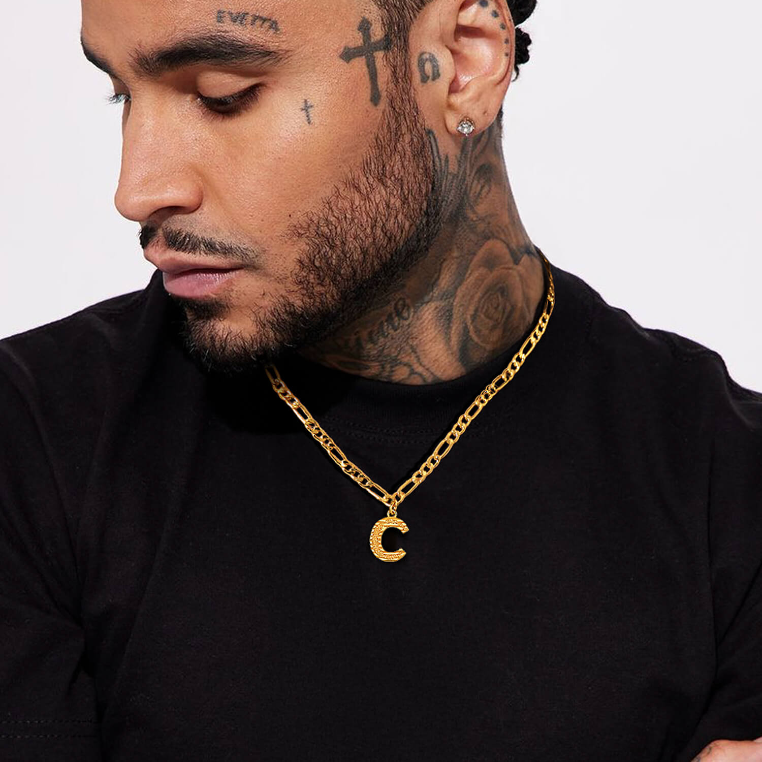 man wearing gold initial necklace