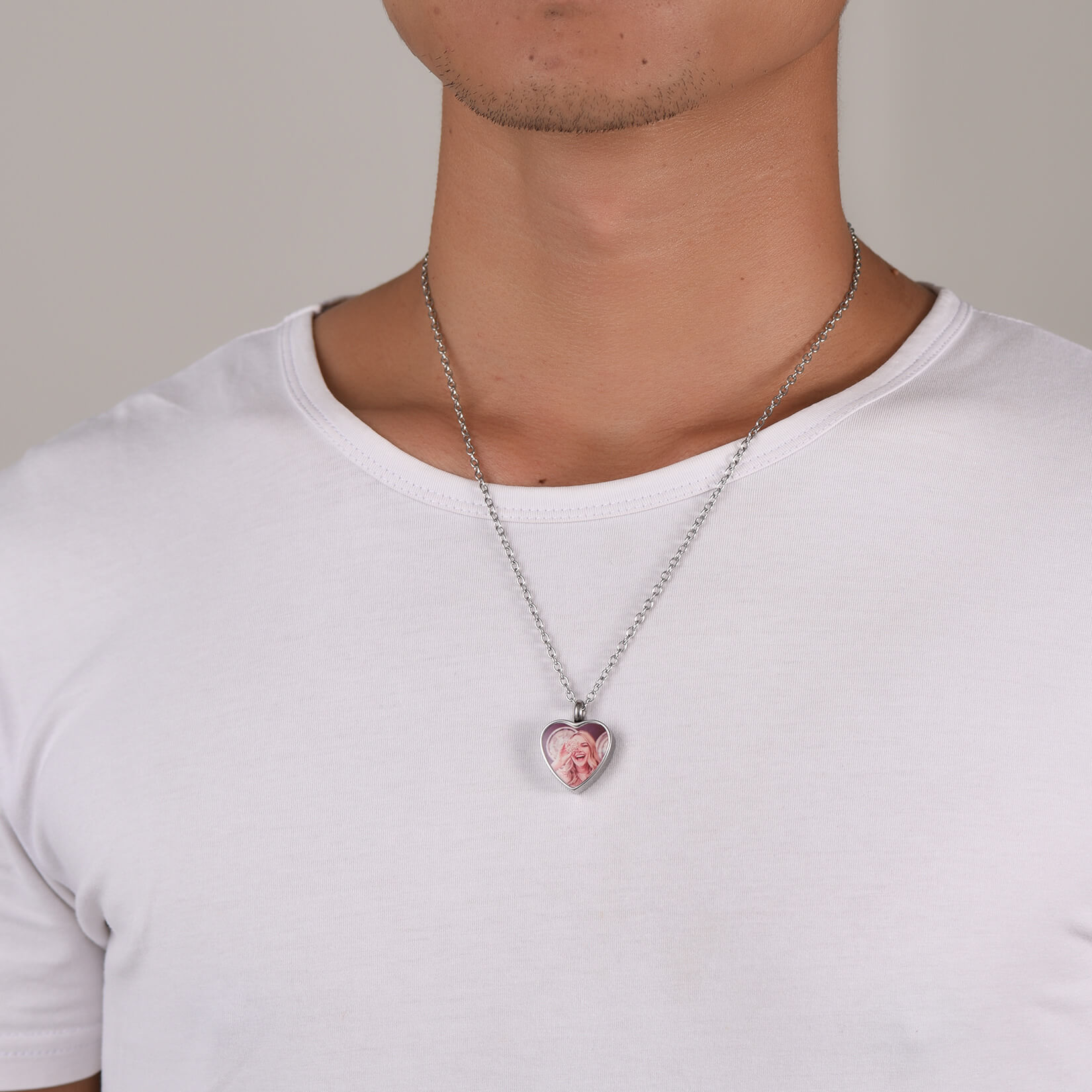 man wearing silver heart urn necklace