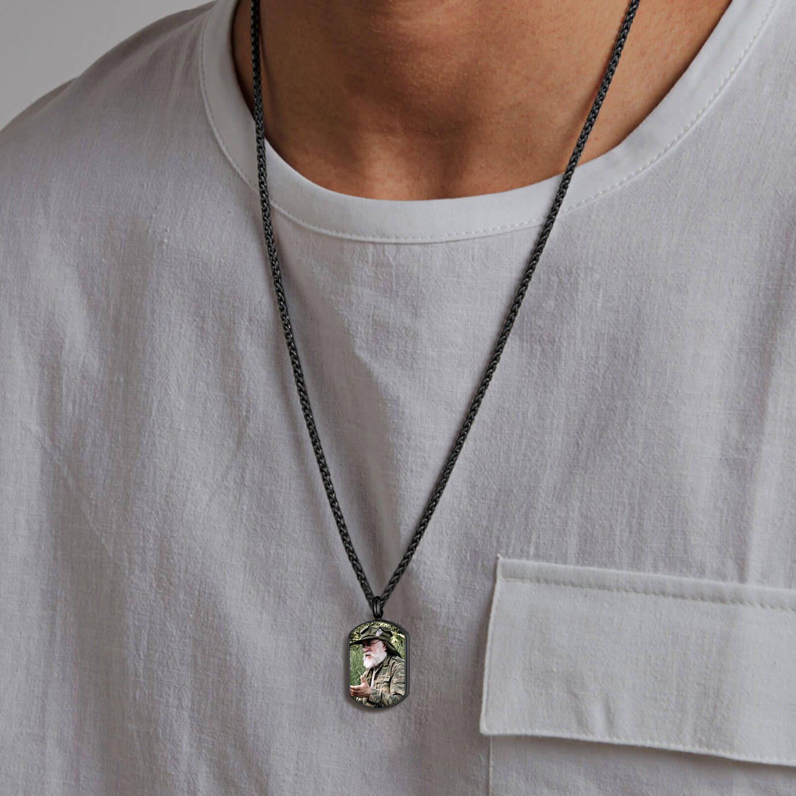 man wearing black urn necklace for ashes