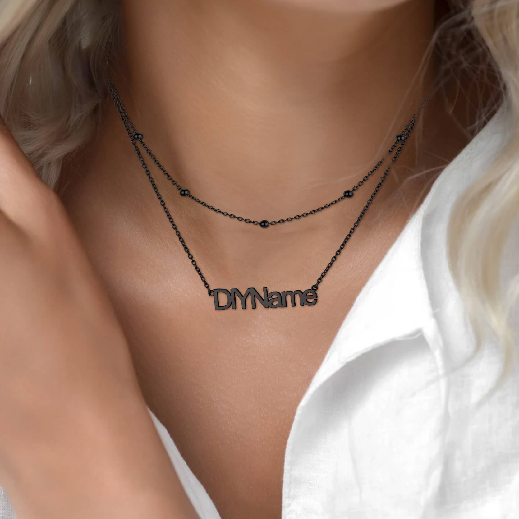 woman wearing black name necklace