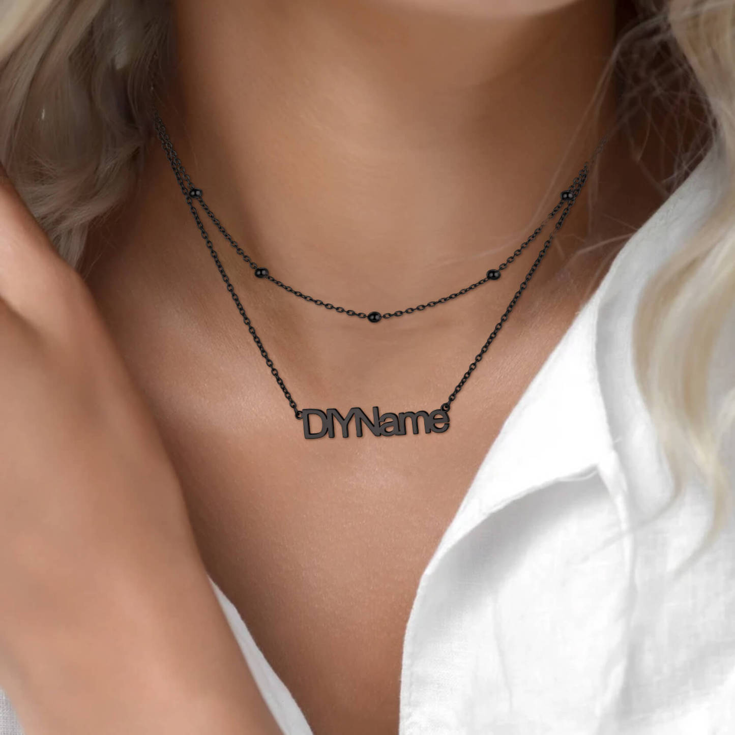 woman wearing black name necklace