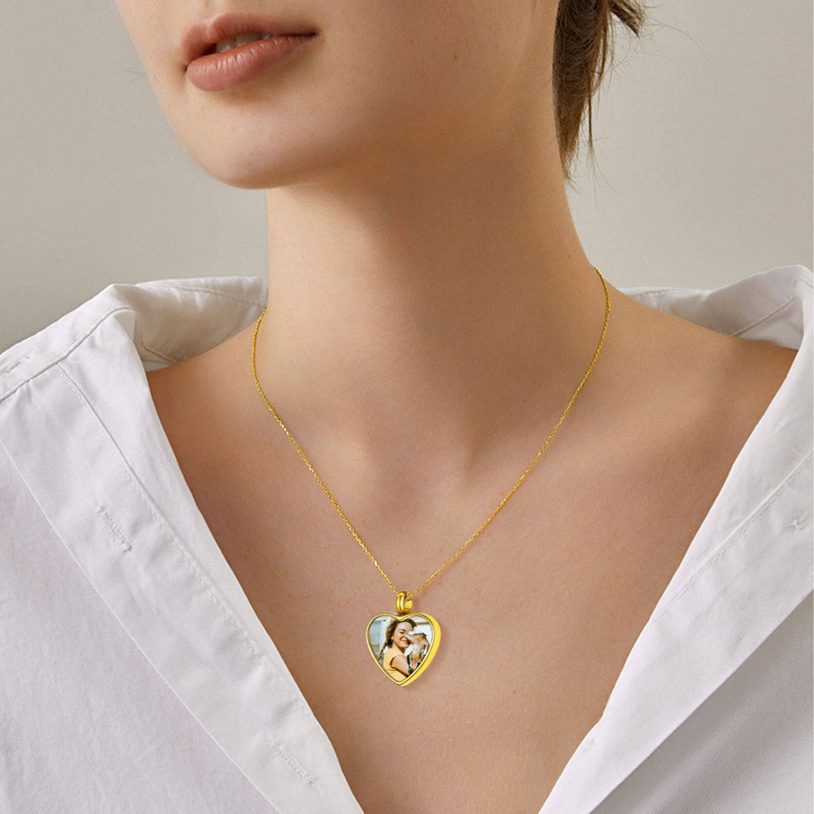 woman wearing gold heart urn necklace