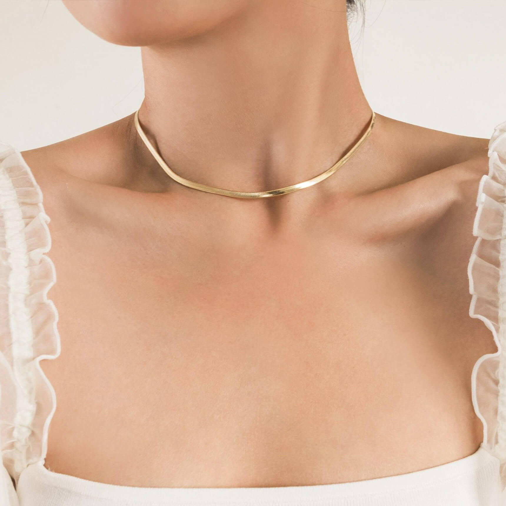 woman wearing gold Herringbone Chain Necklace