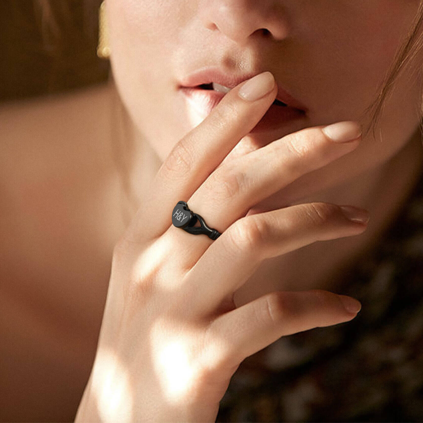 women wearing black urn ring