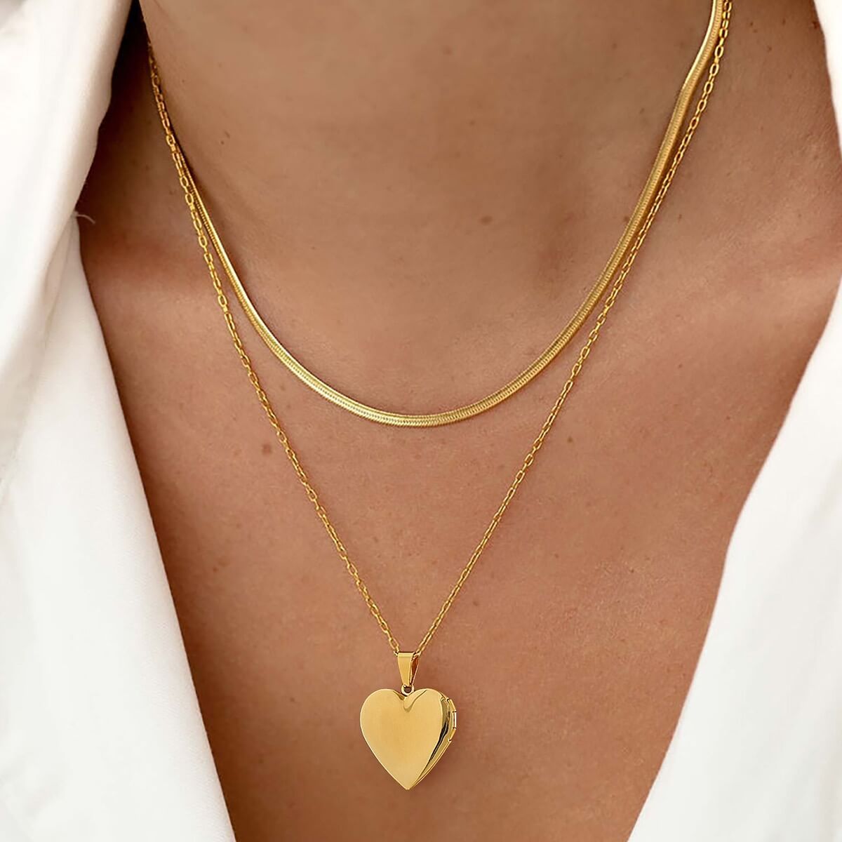 woman wearing gold locket necklace