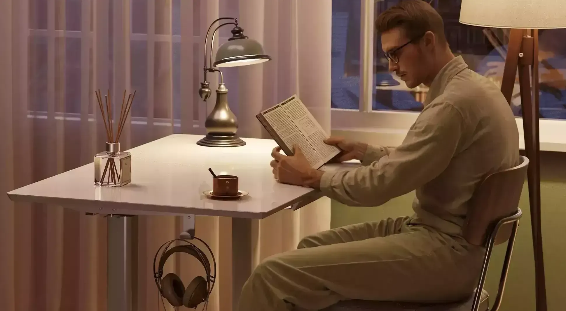 A man is sitting at a lifting table reading a book