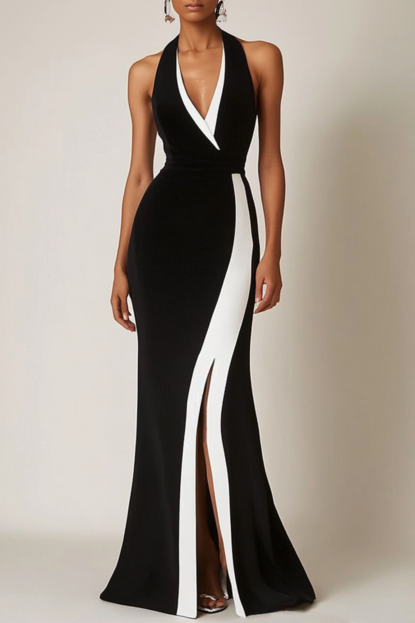 Model wearing a black halter dress with white panels and a V-neck, styled for evening formal occasions.