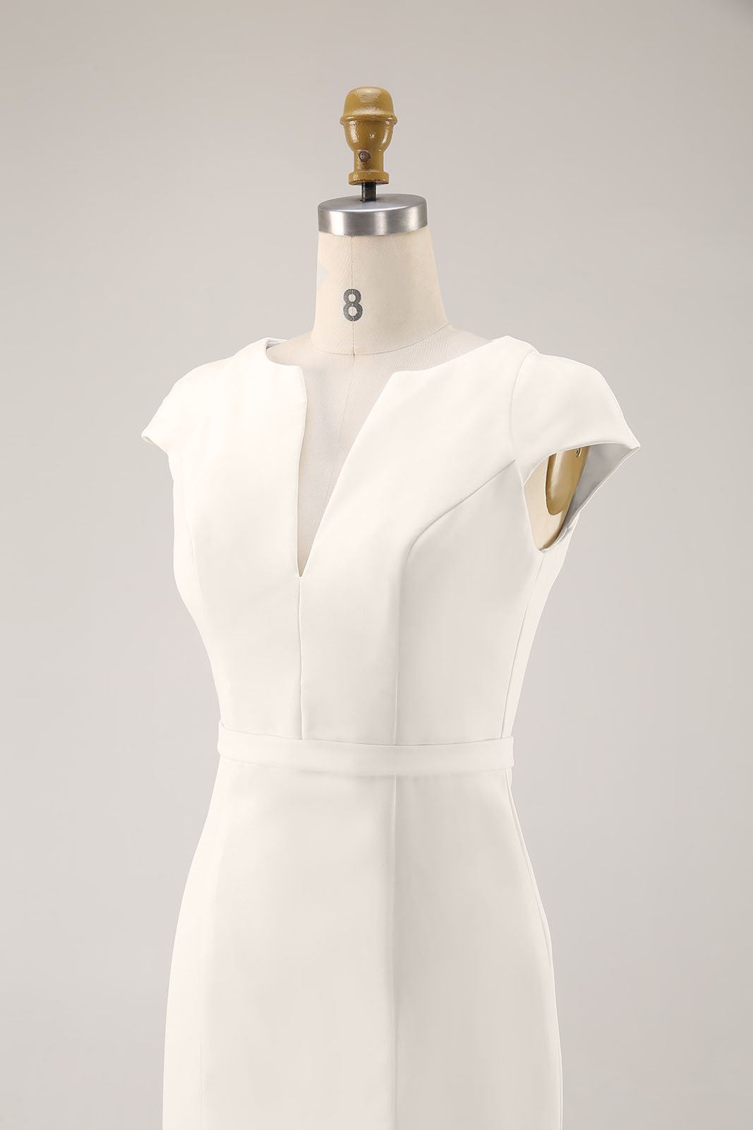 Elegant business outfit for women featuring white dress and sleek design