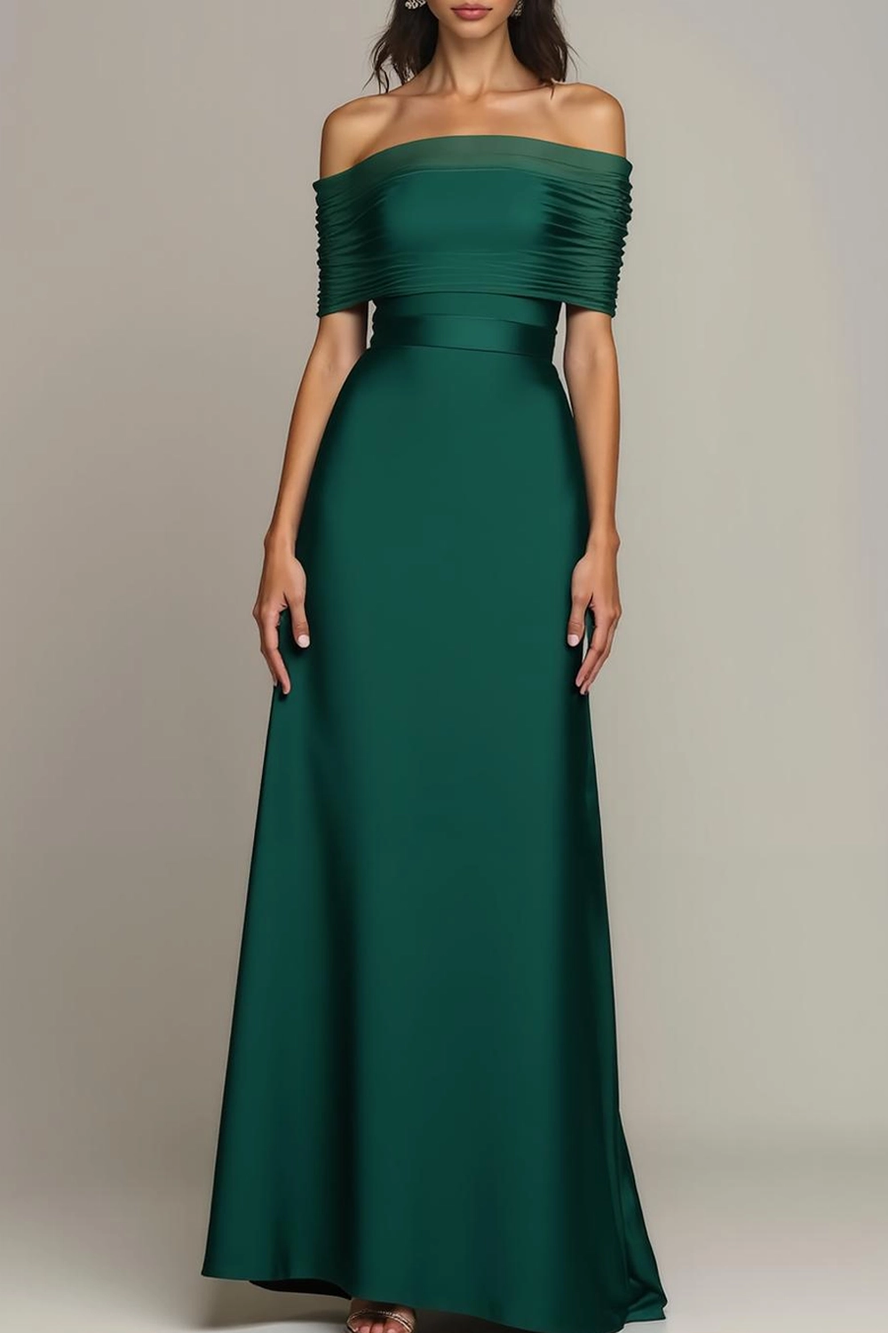 "Floor-length emerald green off-the-shoulder formal gown with a ruched bodice and flowing satin A-line skirt on a neutral background."