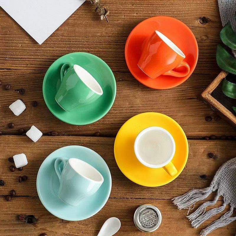 Overhead view of multicolor 2.5 oz ceramic espresso cups with matching saucers
