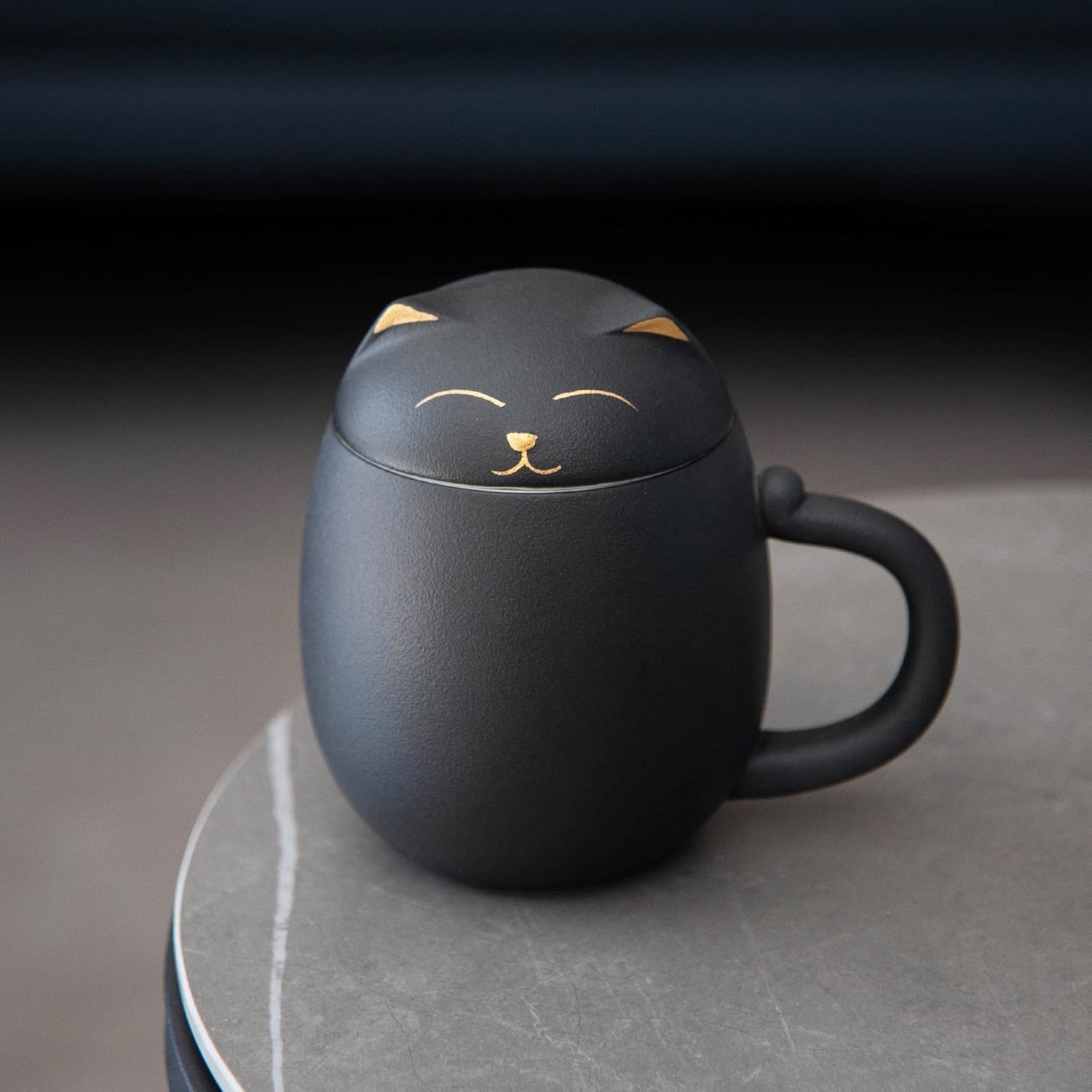 Ceramic tea mug with tea strainer insert shown on the table