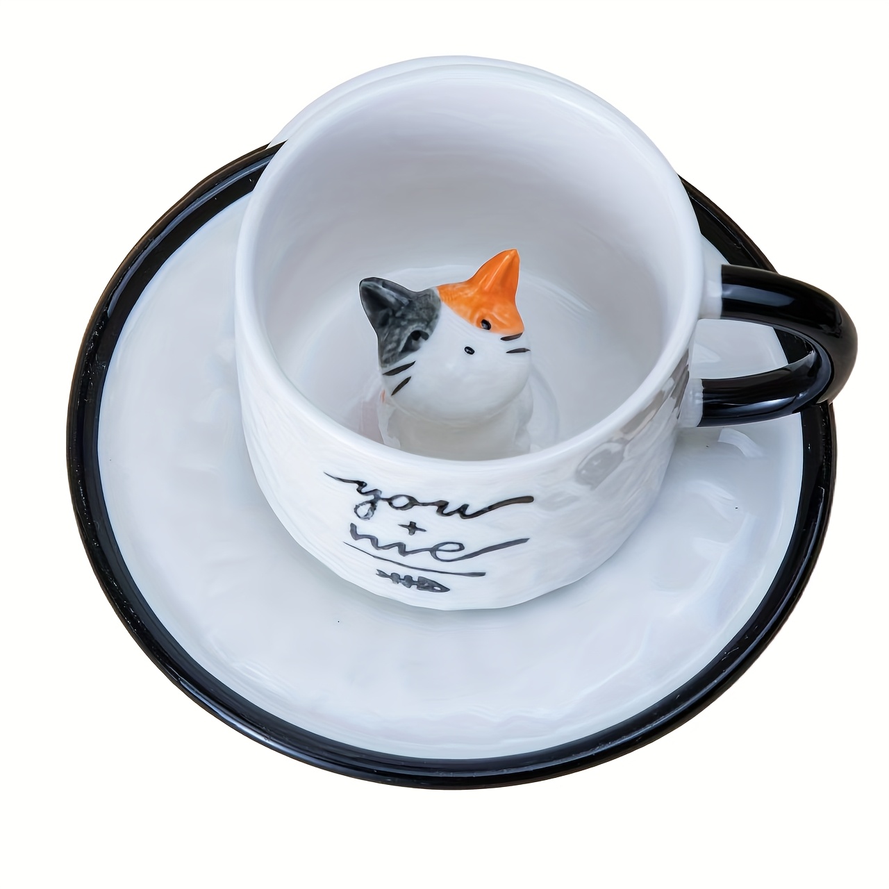 Kitten inside cup with black handle and saucer rim