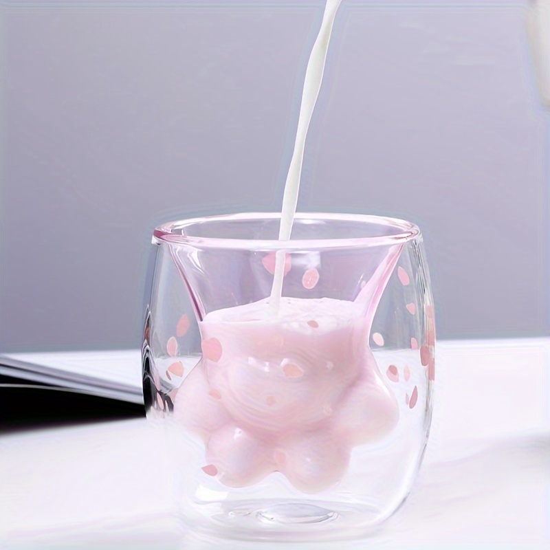 Cat paw cup with milk being poured into pink paw glass