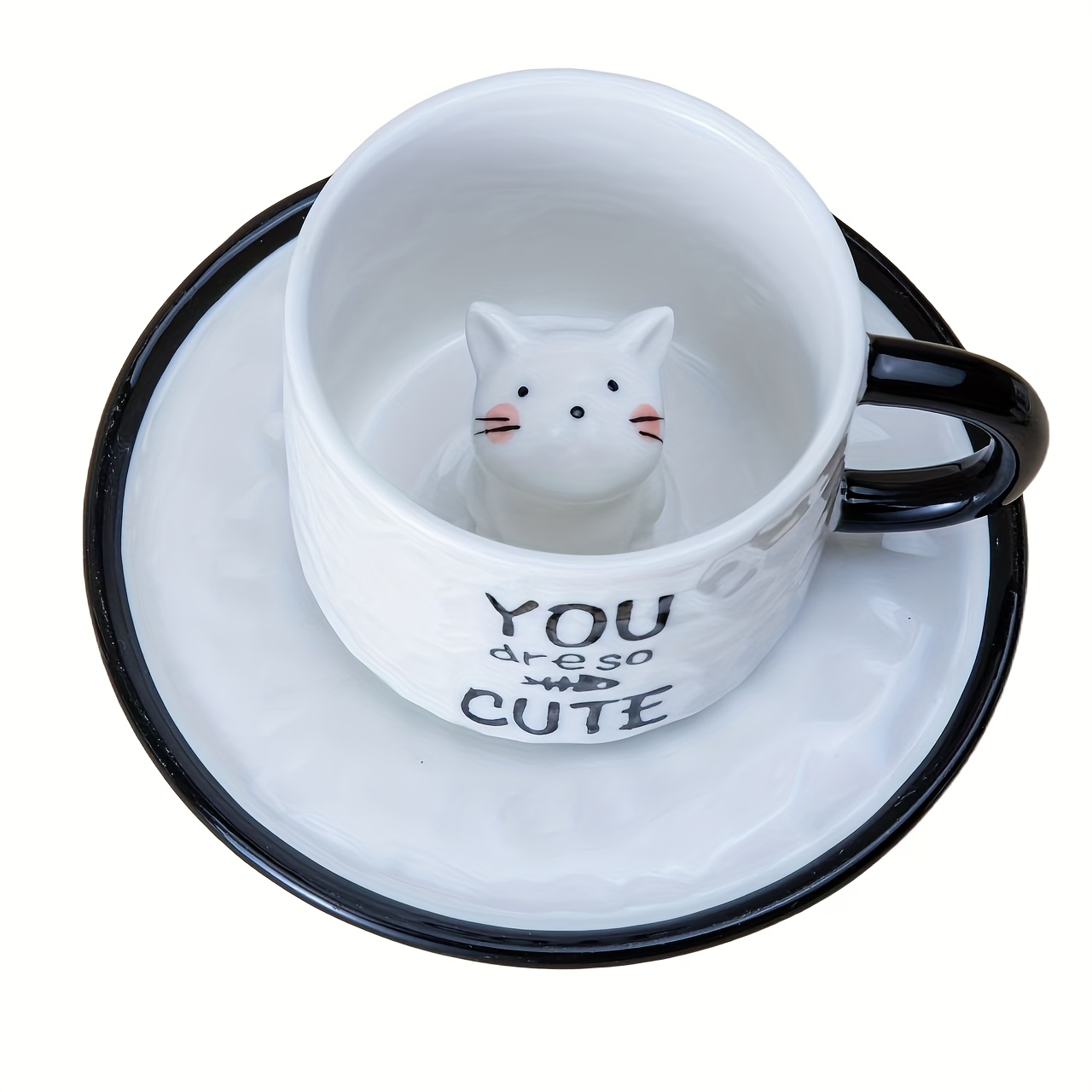 Little white cat inside ceramic cup and saucer