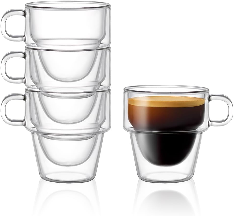 Stacked set of four clear 5 oz double wall espresso cups with one cup filled with espresso
