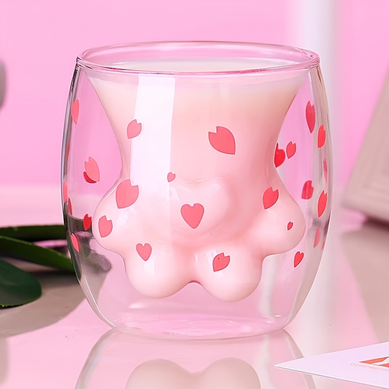 Pink cat paw cup close-up with heart paw pattern