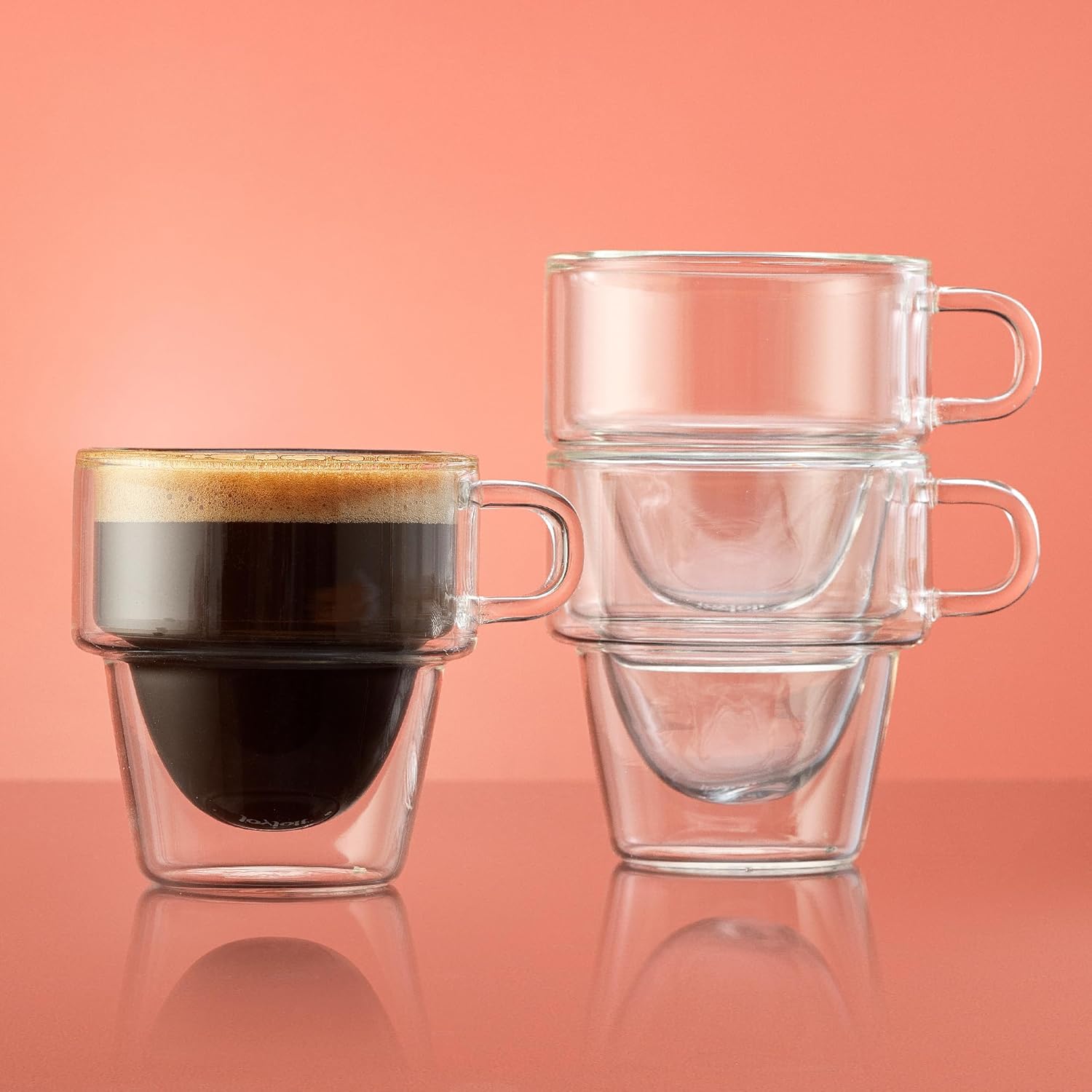 Filled 5 oz cup and stacked clear cups shown together to highlight stackable storage