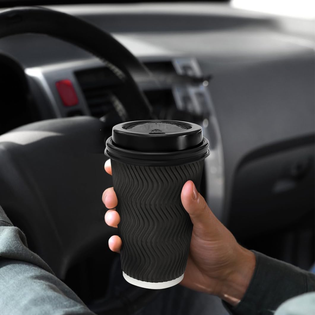 Black ripple wall paper cup held in a car for takeaway coffee
