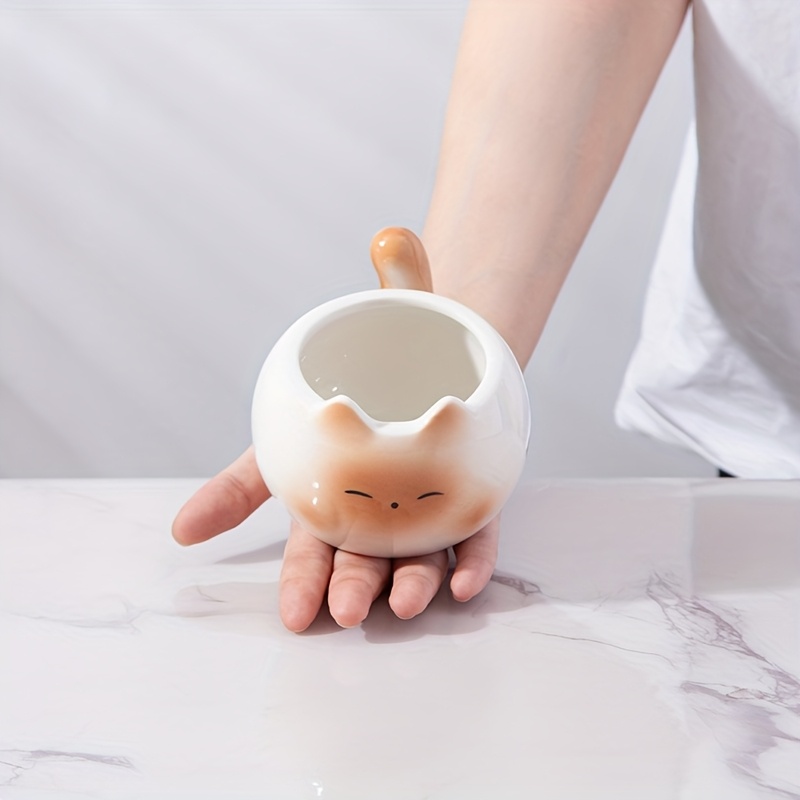 Siamese cat coffee mug held in hand